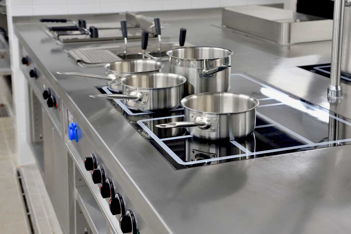 Stainless Steel Pots Built On The Stove In The Restaurant Kitchen